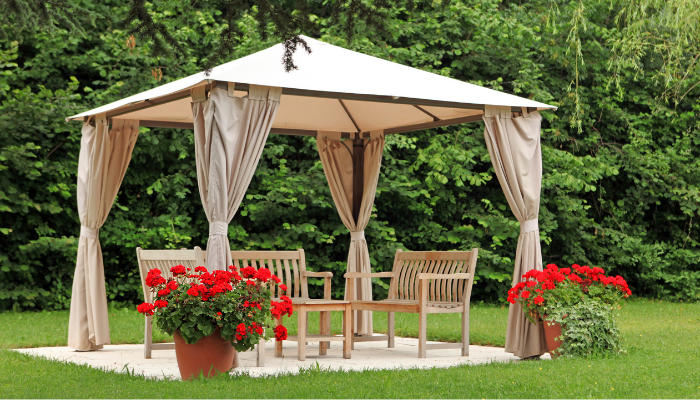 simple square pergola with fabric shade top and drapes